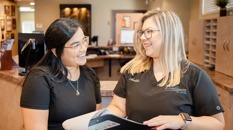 Smiling Staff Member Welcoming Patient To Pray Chiropractic - Ringgold