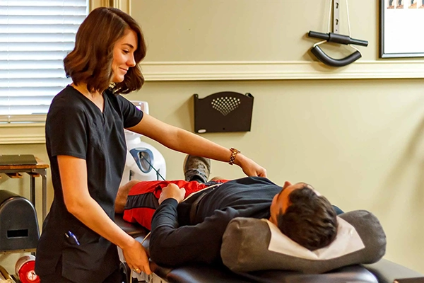 Staff Member Helping Patient In Decompression Machine