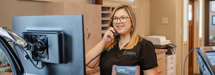 Staff Member Taking Call At The Front Desk